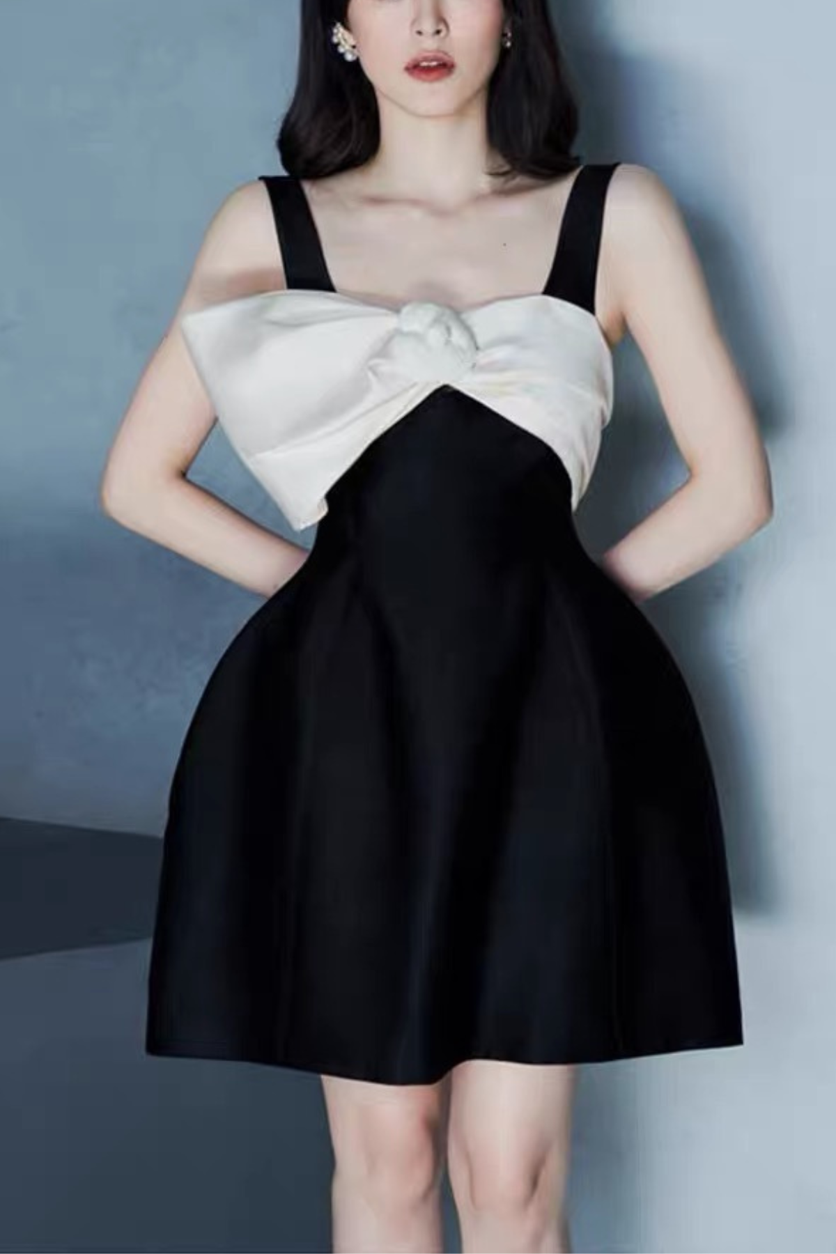 Black Sleeveless Mini Dress with Statement Bow and Structured Skirt Avalabel