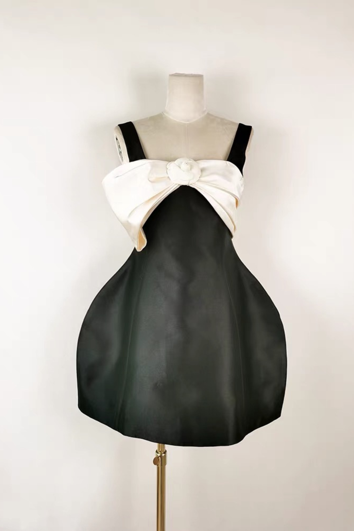 Black Sleeveless Mini Dress with Statement Bow and Structured Skirt Avalabel