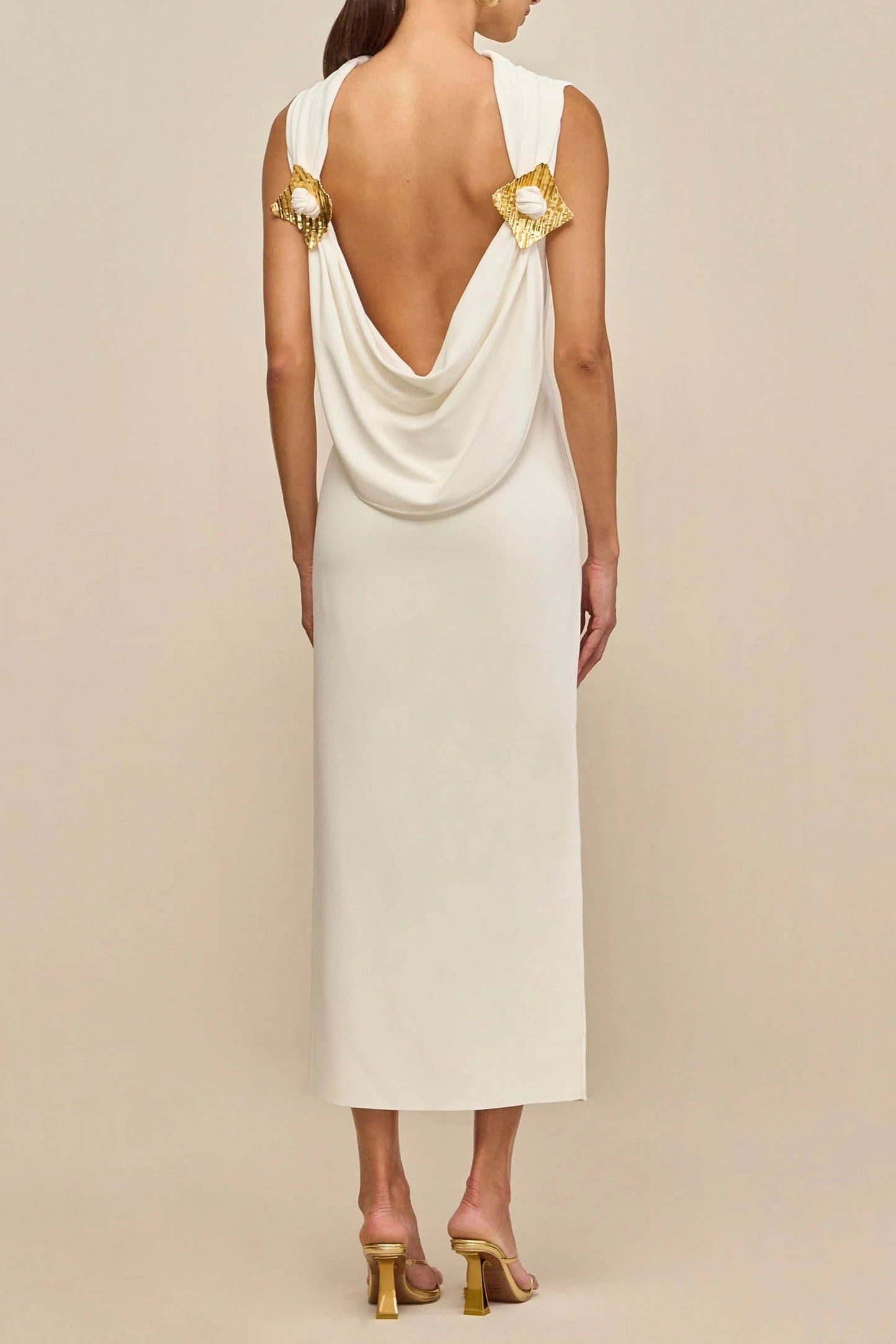 white sleeveless backless knit midi dress with two pleated golden embellishments