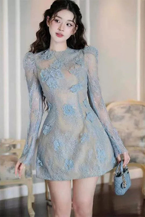 Woman wearing a light blue lace dress in an indoor setting
