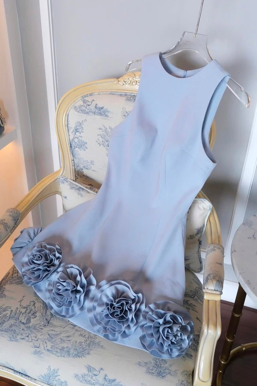 Light blue dress with floral details on a chair