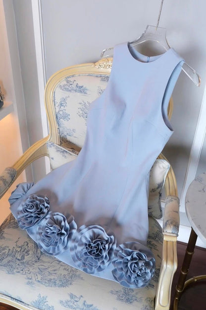 Light blue dress with floral details on a chair