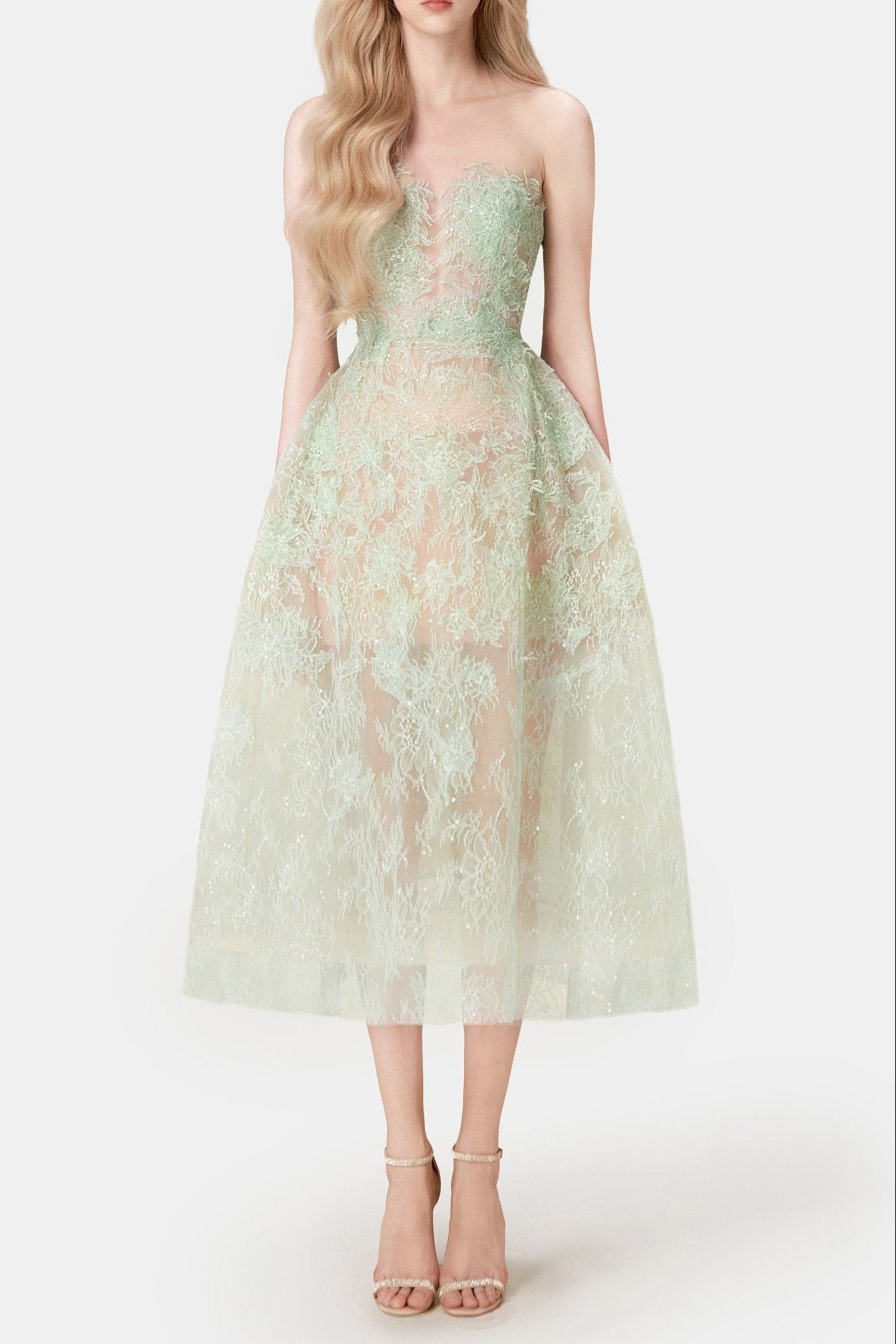 A model wearing an elegant mint beaded lace midi dress with a fitted bodice and flowing skirt, paired with heels.
