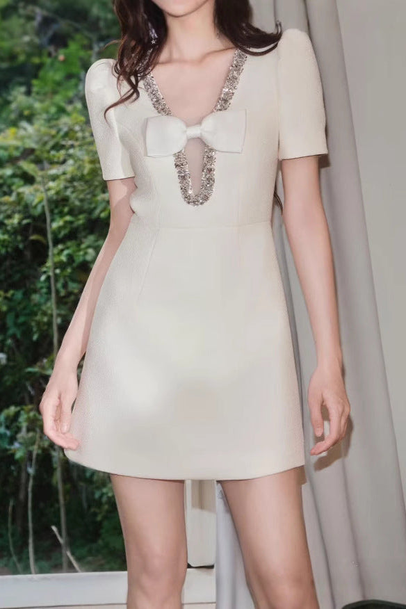 V-Neck Diamond Chain Bow Mini Dress in Ivory Avalabel