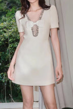 V-Neck Diamond Chain Bow Mini Dress in Ivory Avalabel
